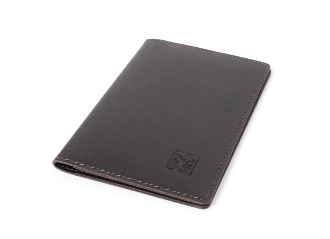 A closed black leather passport cover lying flat, highlighting the smooth texture and embossed square logo.