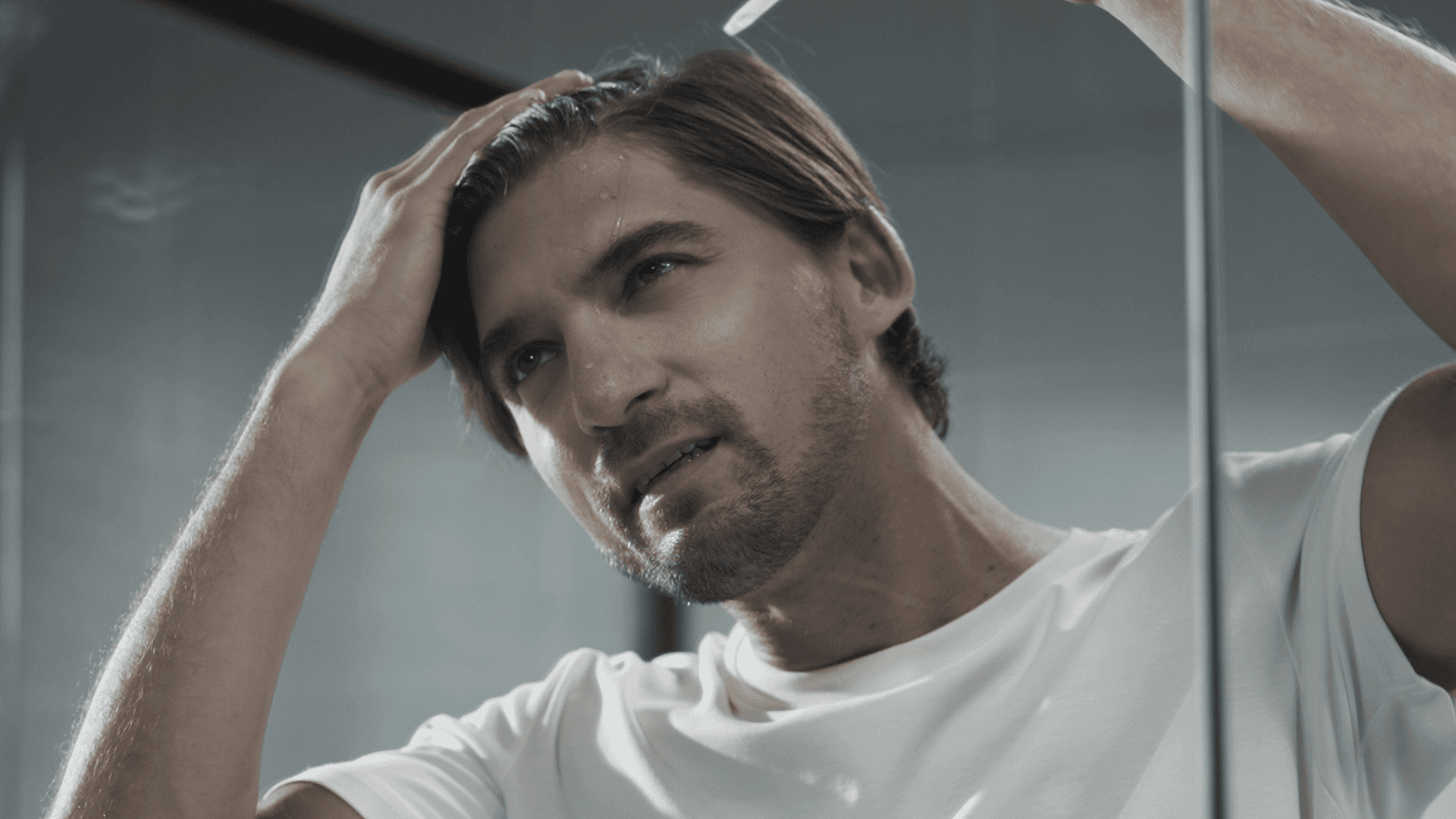 Close-up of minimalist packaging with fine white ribbed texture, a curved green accent, and black typography on a dark background.