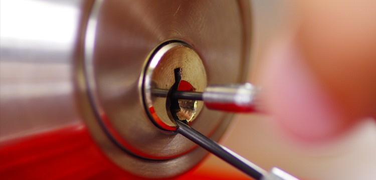 locksmith picking a deadbolt