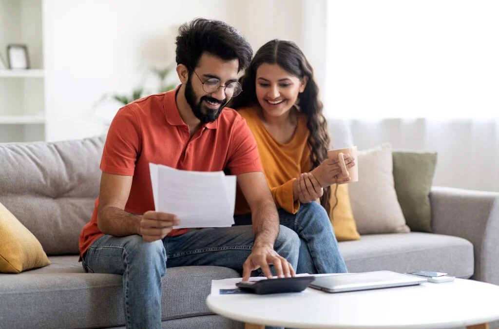 Man and woman doing calculations on couch