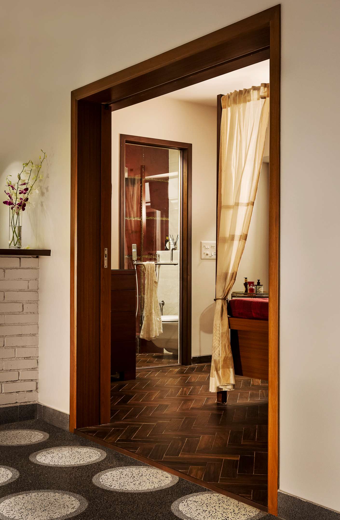 Nature-inspired preschool entrance with sculptural tree partitions and suspended green leaf ceiling panels.