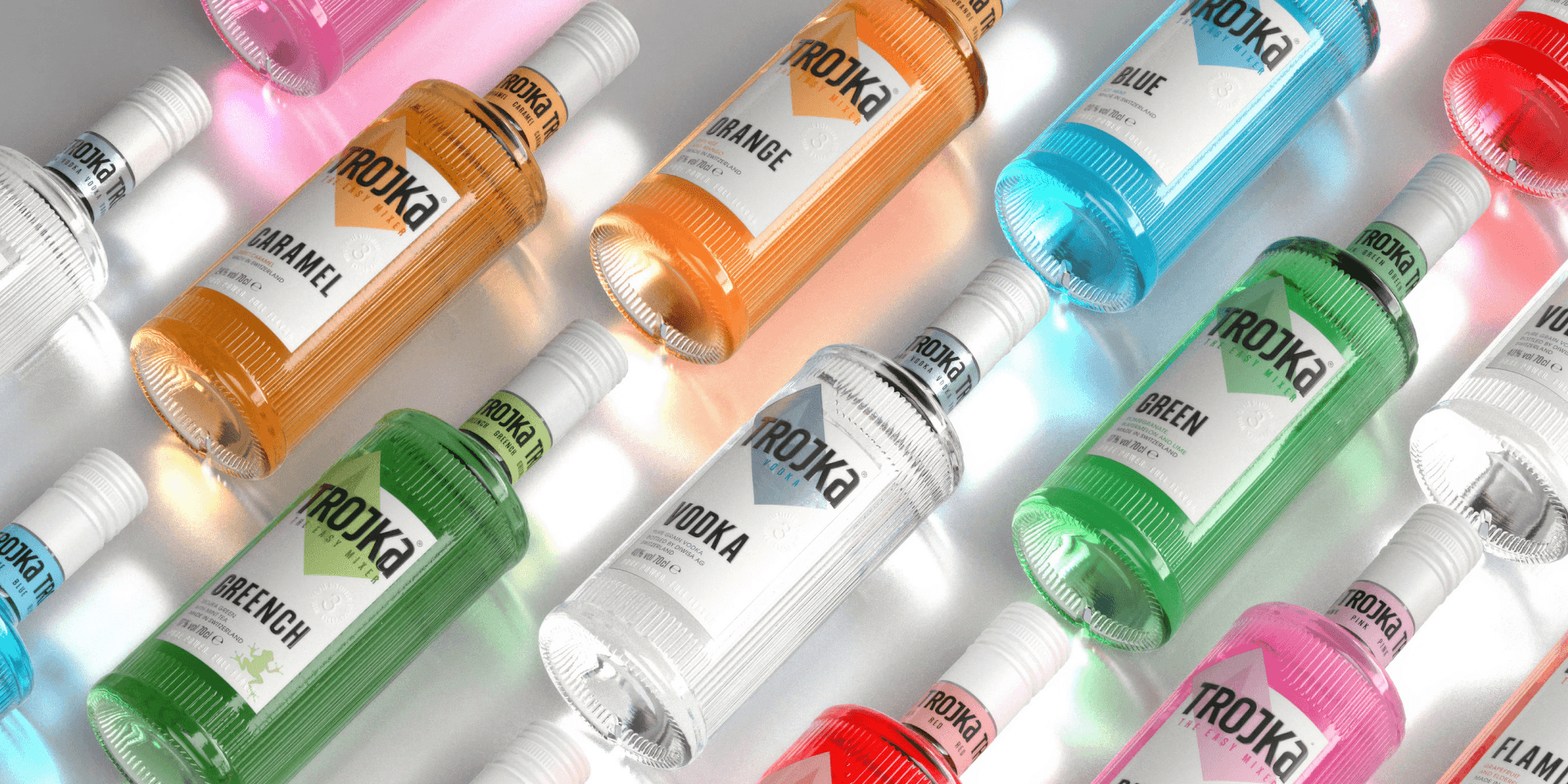 Markenwelt Trojka – Wodka-Flaschen in vielen Farbvarianten (Vodka, Caramel, Orange, Blue, Green, Greench, Flame) im Neonlicht-Setting.