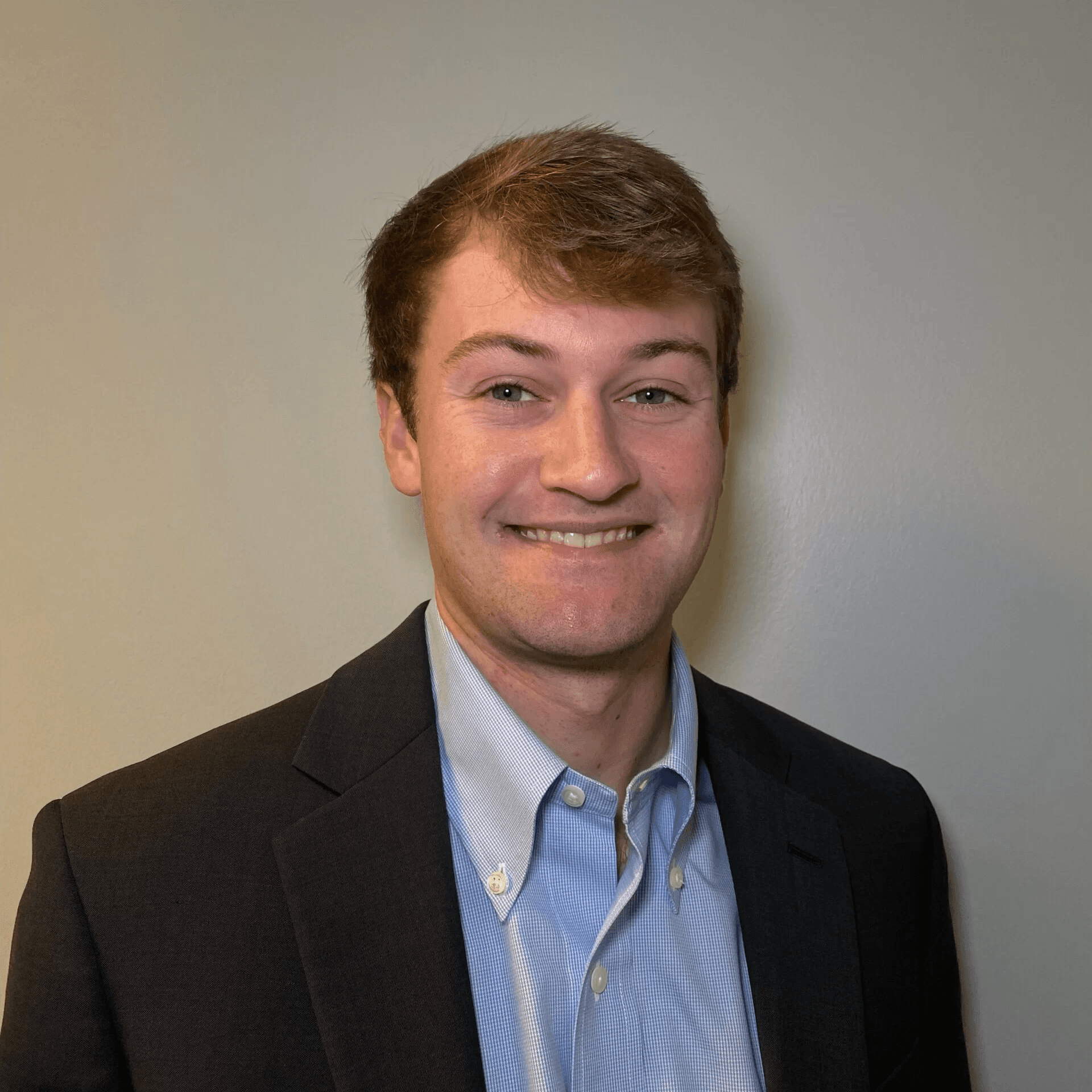 Matthew Moser, Professional headshot of a smiling young man in a blazer and light blue shirt.