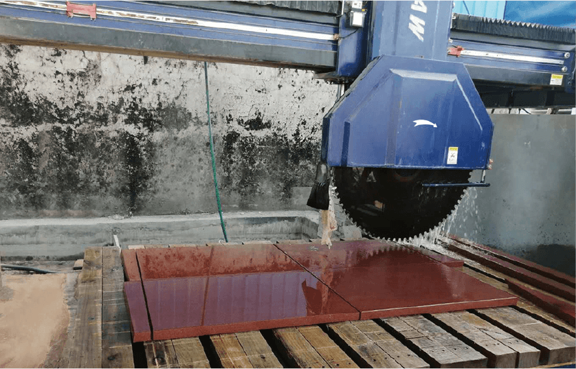 The Dinosaw Bridge Cutting Machine cutting a granite slab, demonstrating its efficiency and high-precision capabilities.