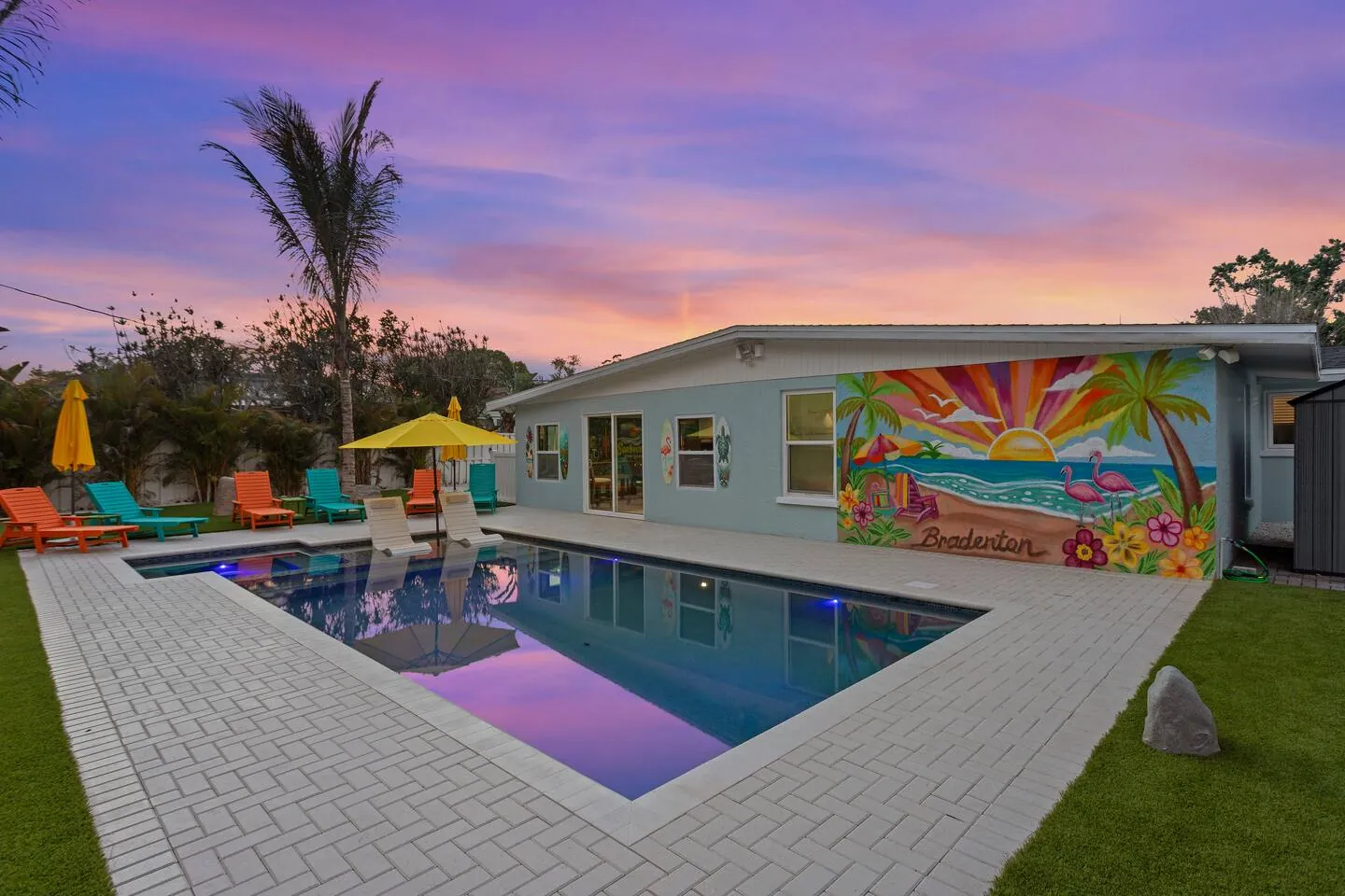 Pool at sunset with house mural at Private Backyard Resort, Bradenton, Florida