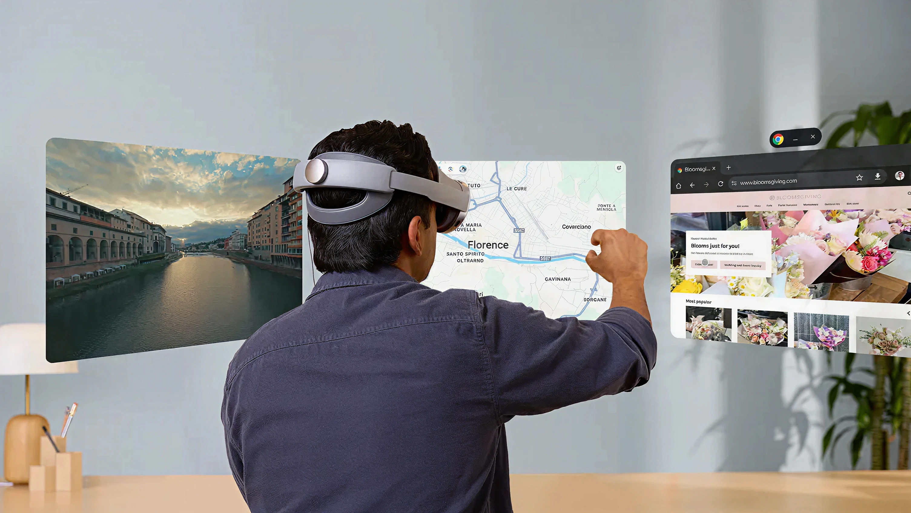 Person wearing Samsung Galaxy XR headset using hand gestures to interact with spatial app windows in an Android XR environment