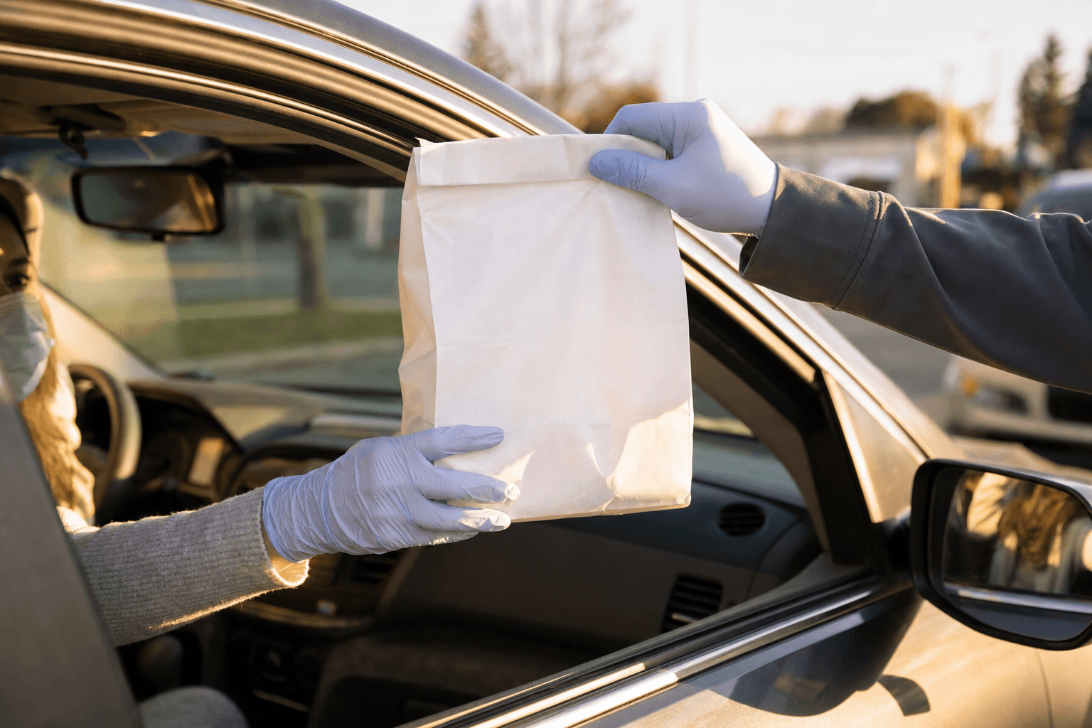Paper bag being handed through car window