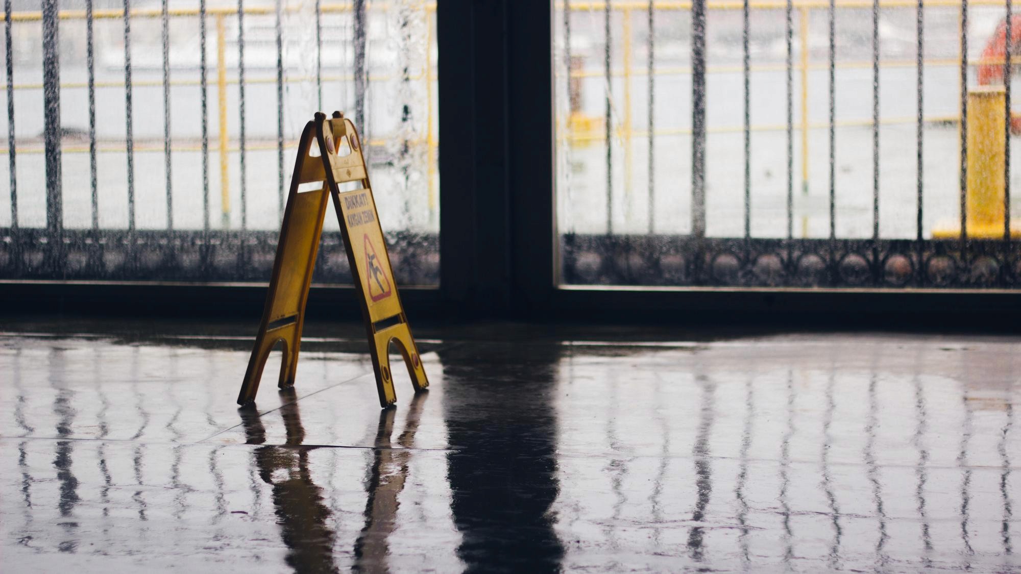 A caution wet floor sign on a flooded floor