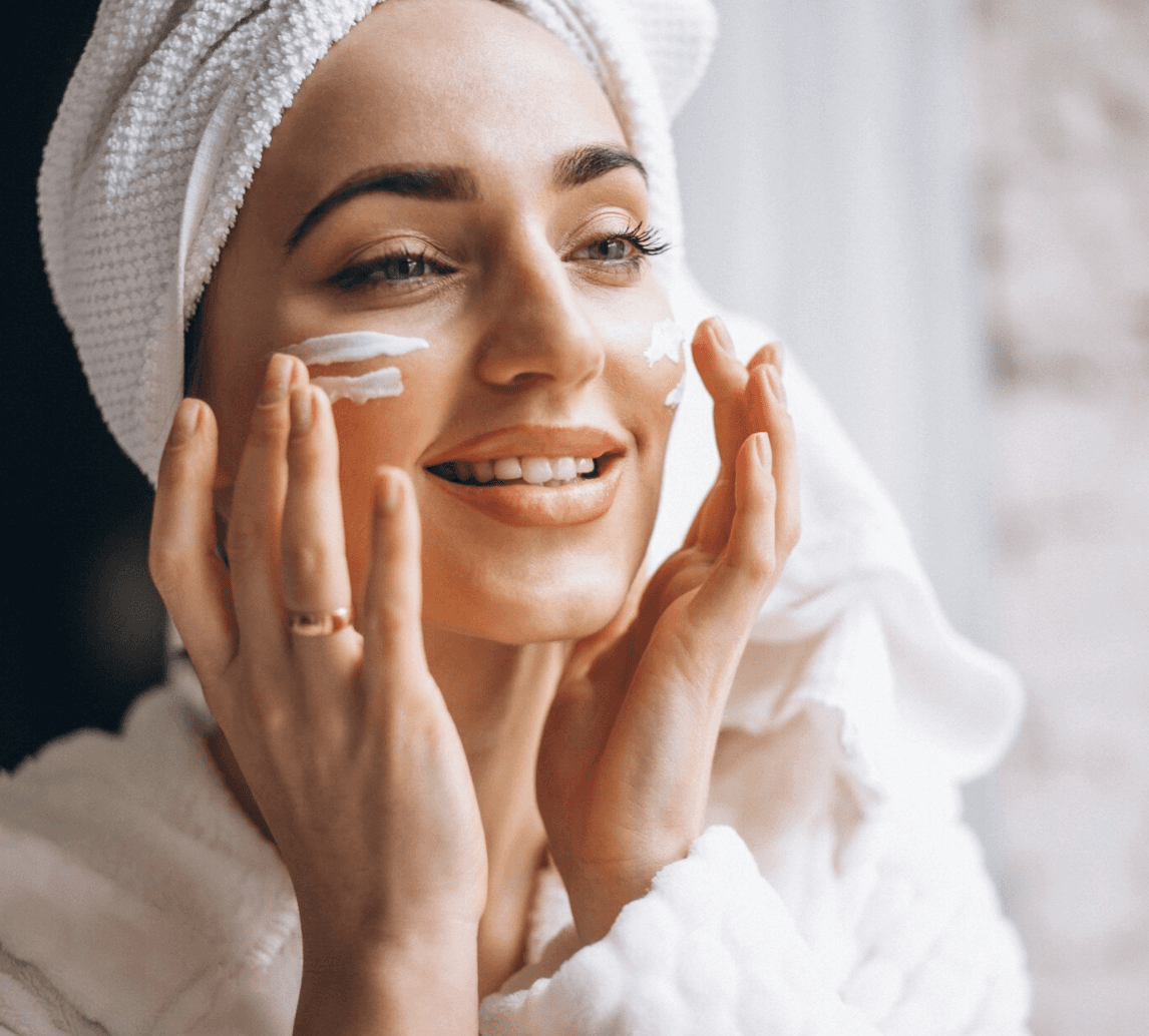 woman applying skincare cream on face