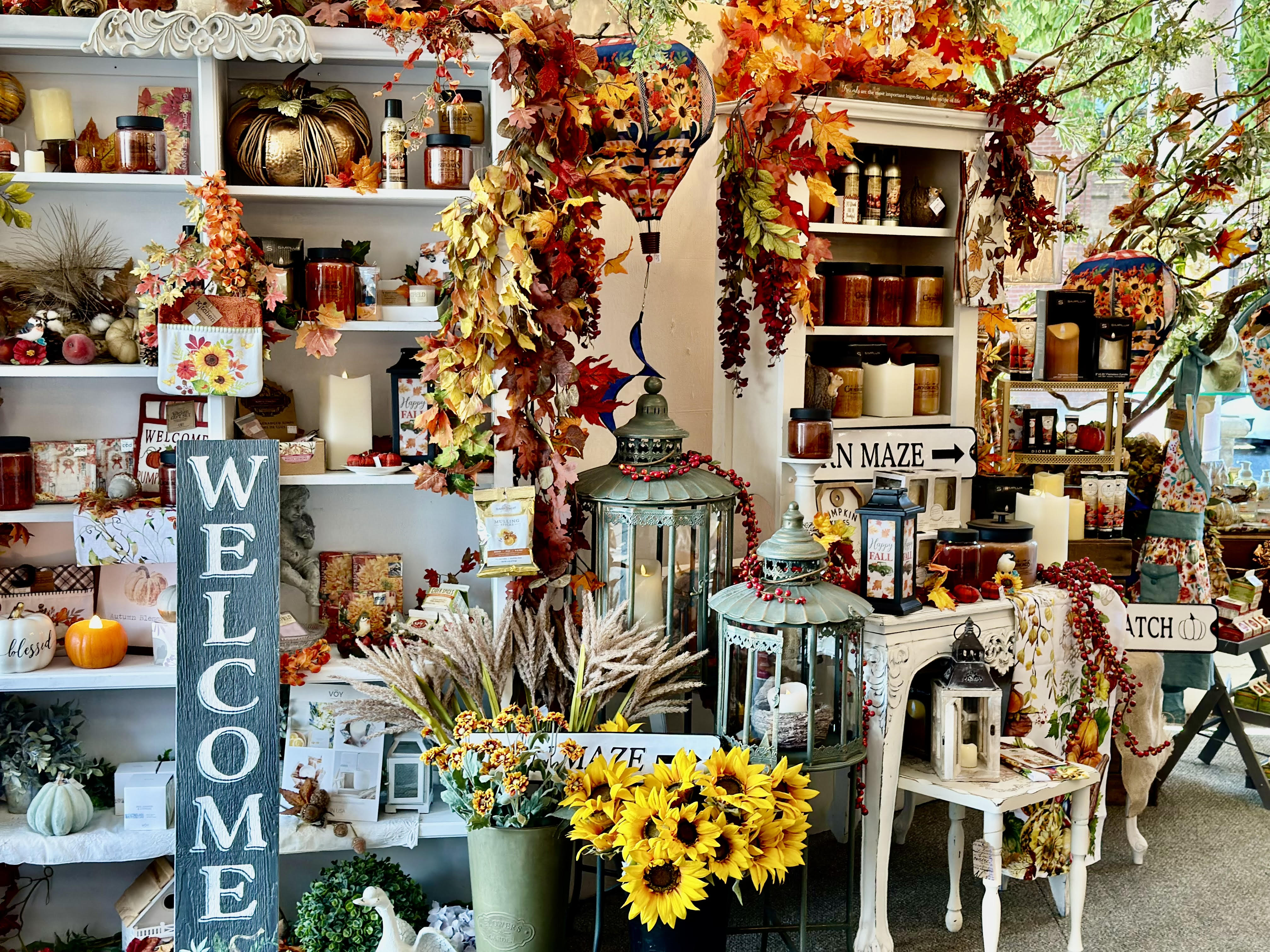 Fall merchandise display with autumn colors, warm scented candles and sunflowers