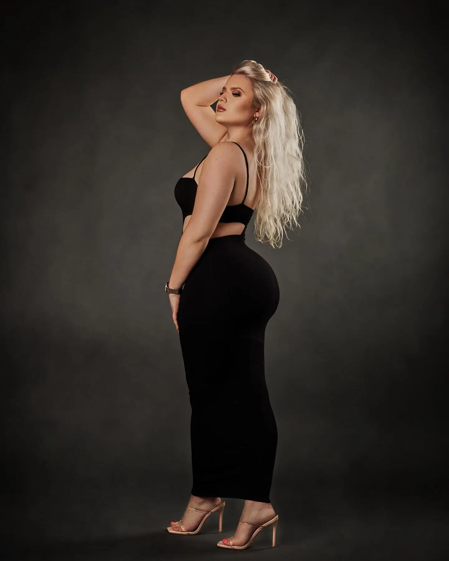 Cliffs overlooking a sandy beach and waves with a crescent moon in the sky