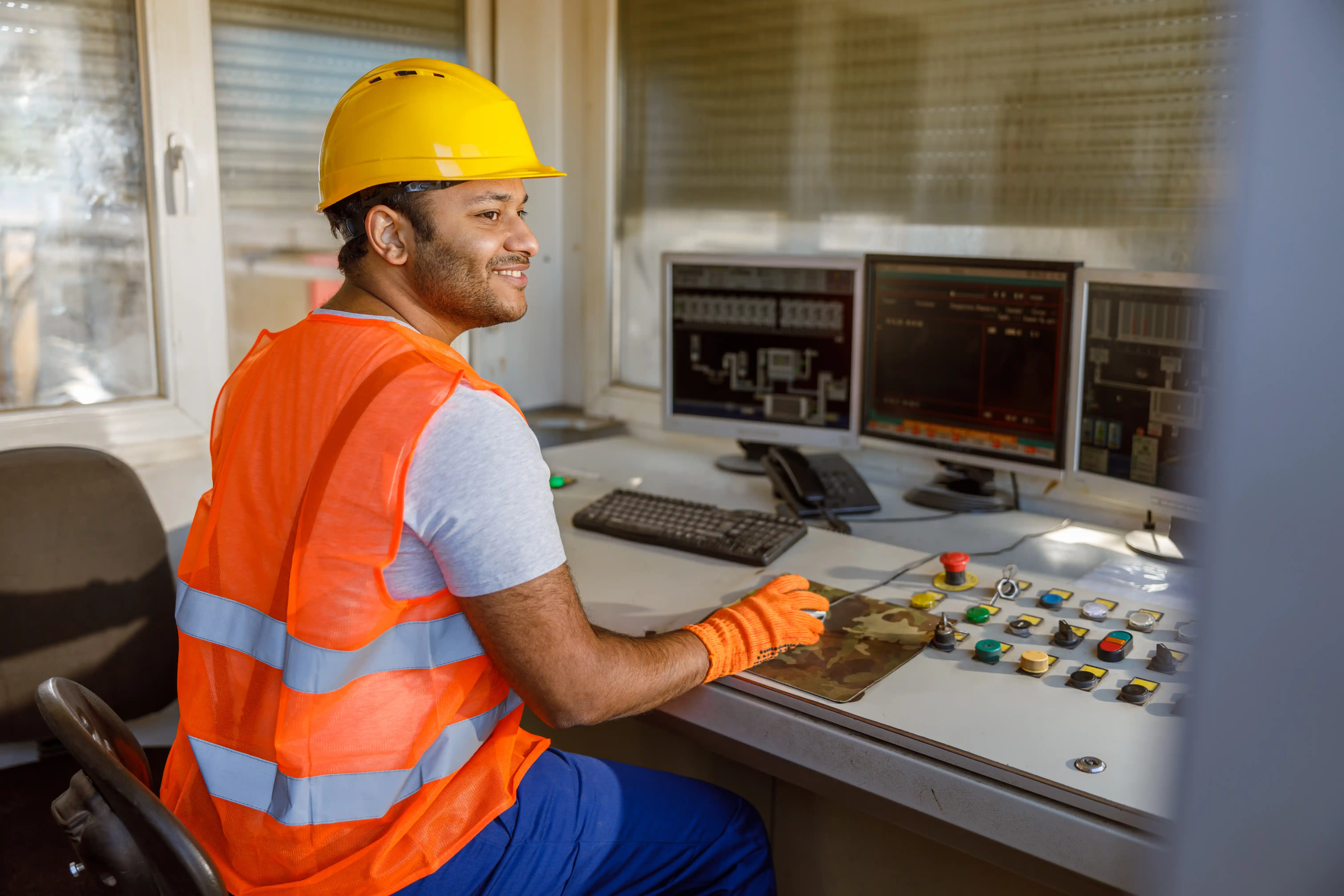 Operator controlling automated concrete batching system using computer interface