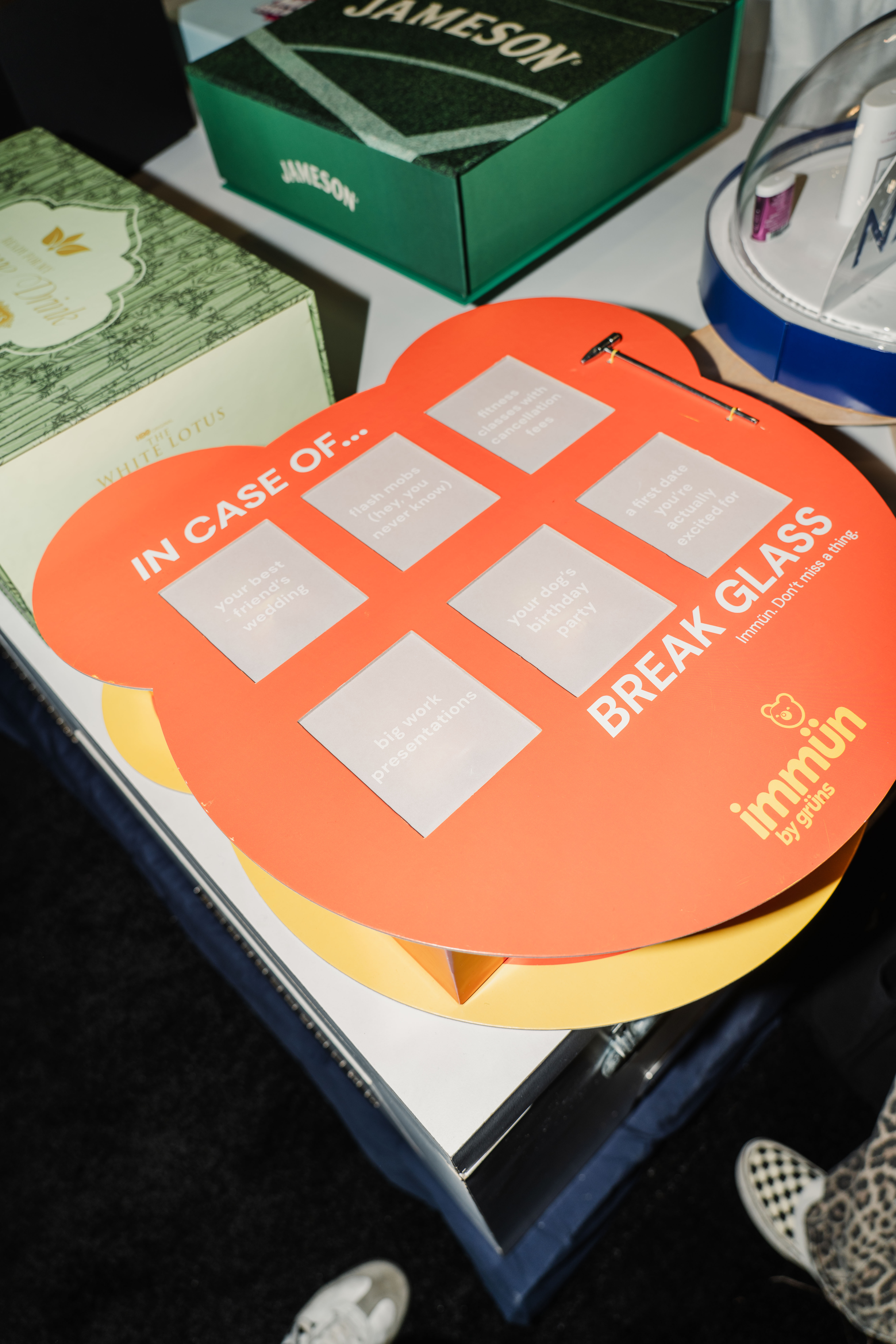 Orange box that has a hammer that you break through the paper to get to the product.