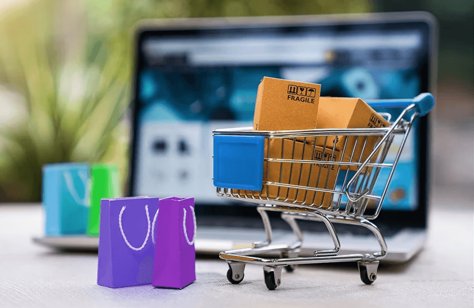 Retail, E-Commerce & Consumer Tech  with shopping bucket and a laptop in baground