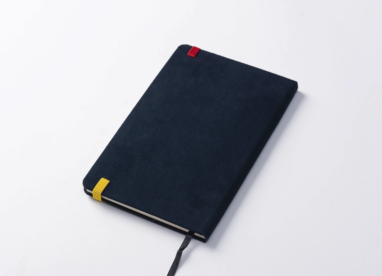 Back view of blue notebook showing colorful strap details and bookmark.