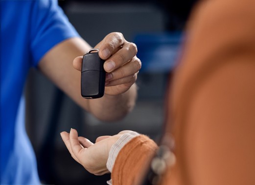 happy ford owners holding new car key made by carkeyaction