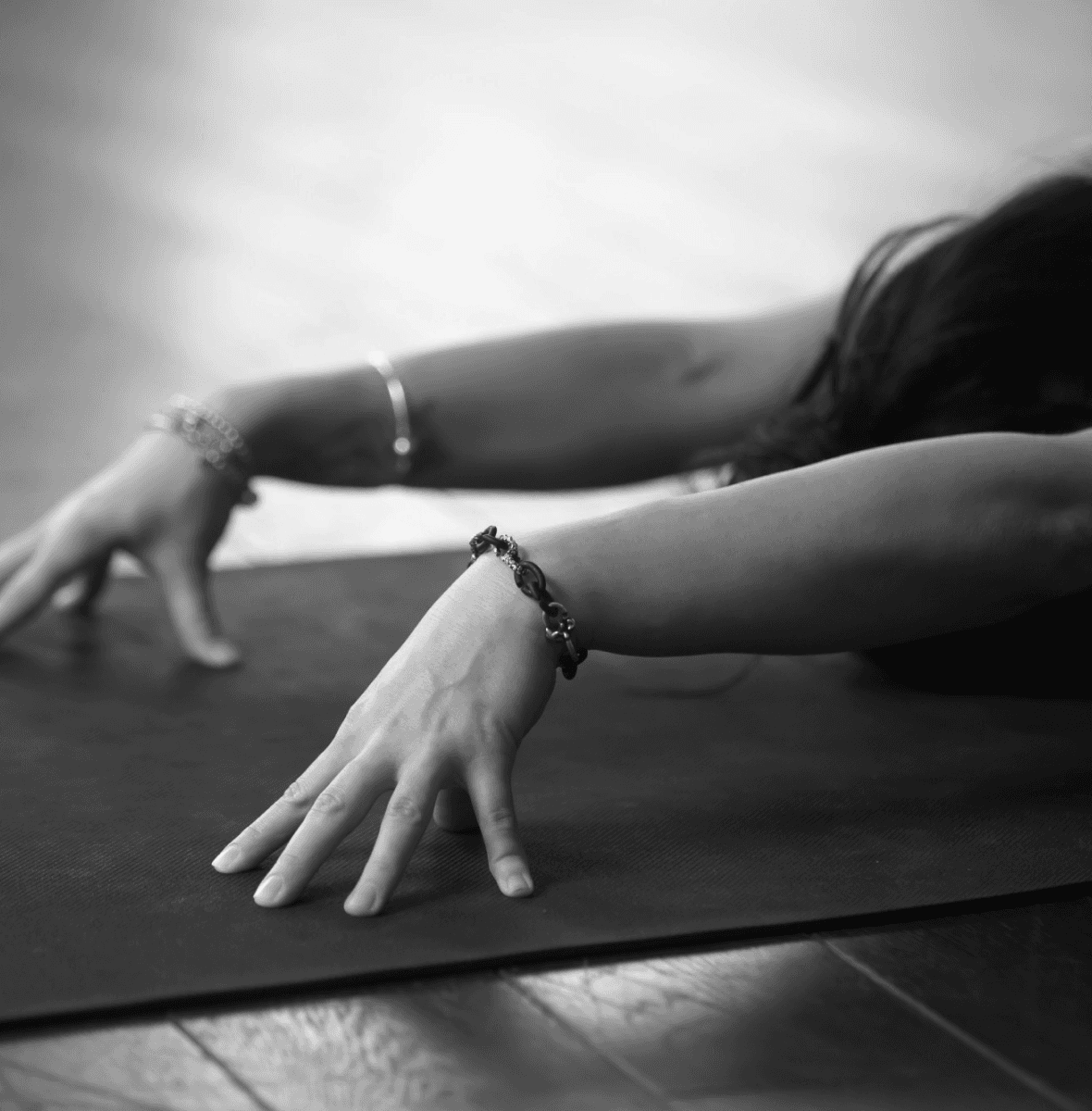 Woman doing slow, mindful stretch on yoga mat