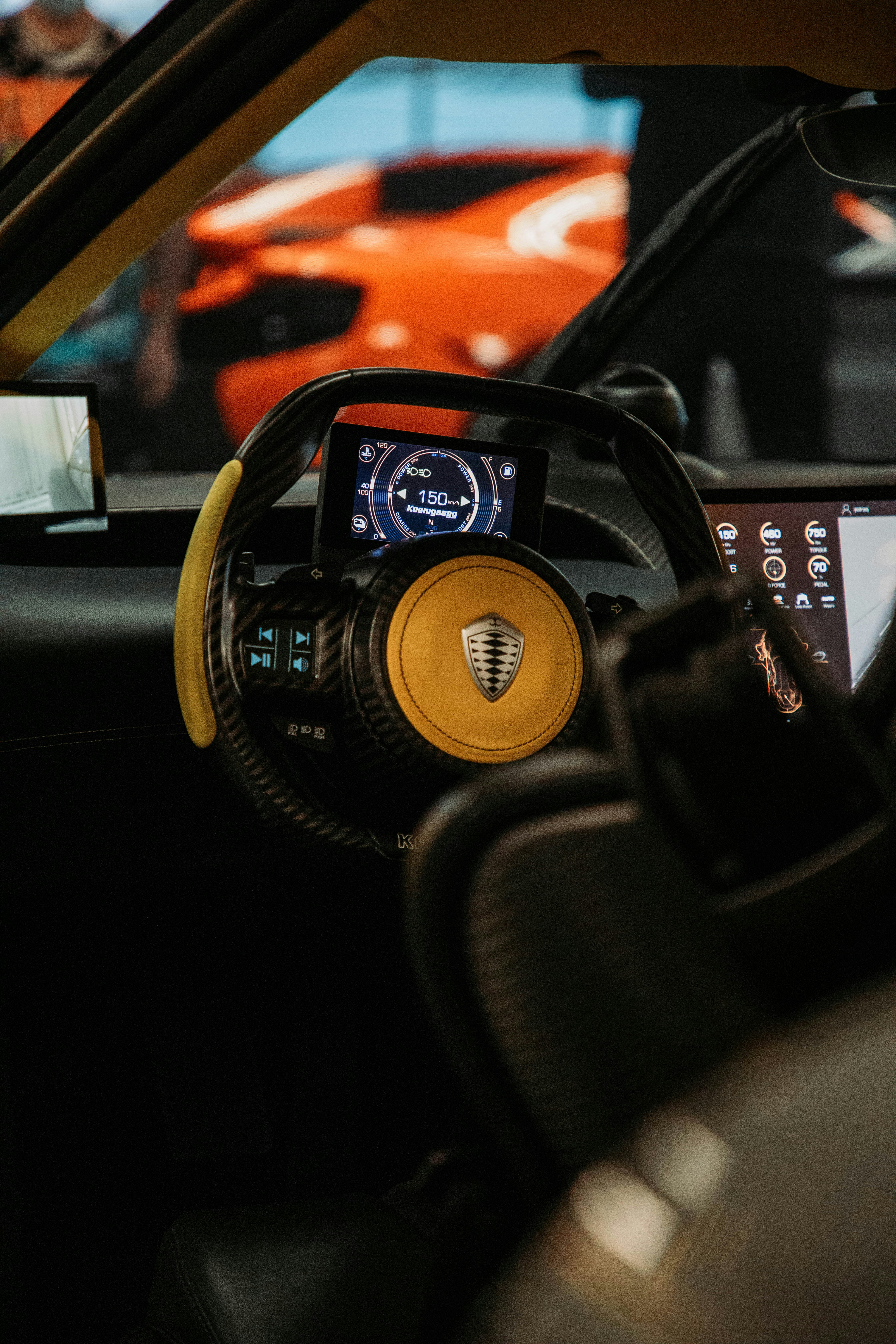 the interior of a car with a yellow steering wheel