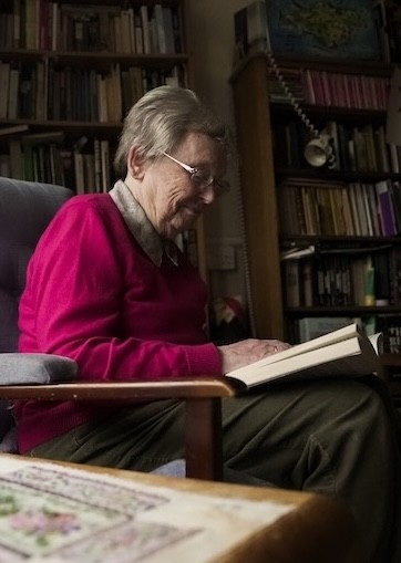 Woman reading in her study.