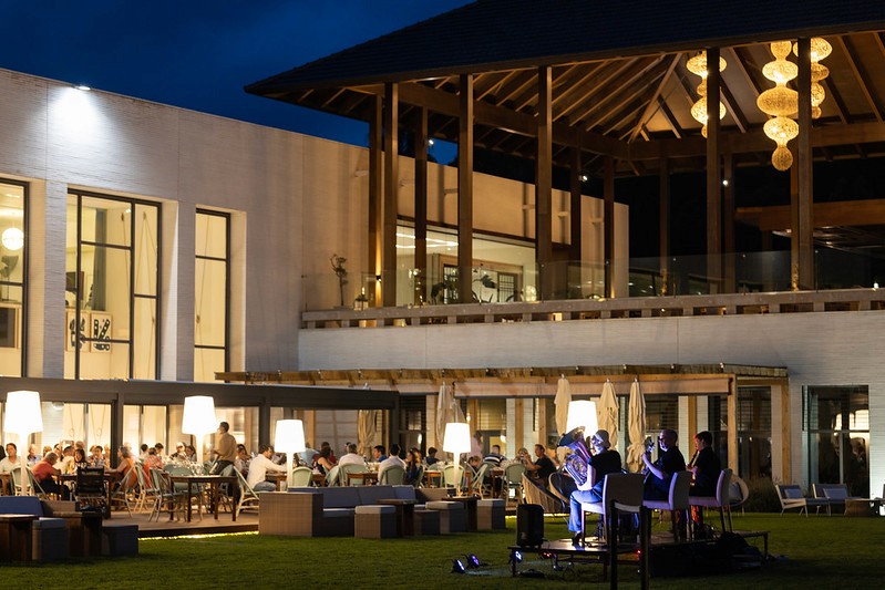 A desk with a laptop and an employee badge laying on top of it.