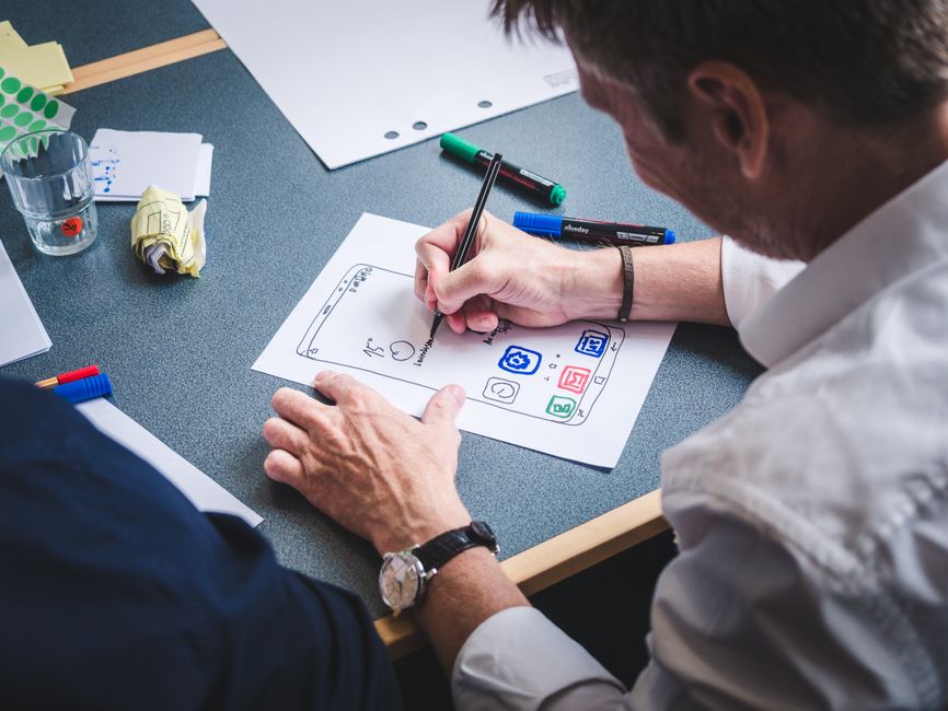 A UX designer wireframing a modern website layout on a digital tablet