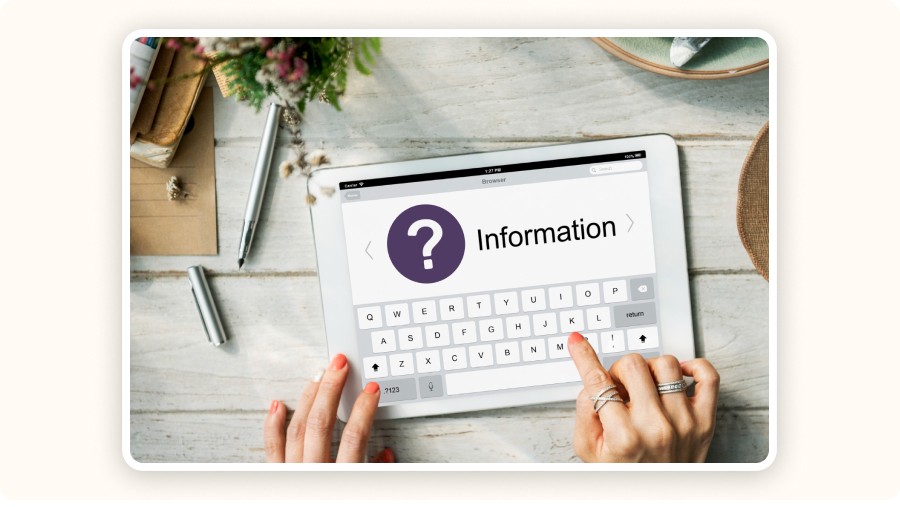 Hands using tablet displaying information search screen with question mark icon