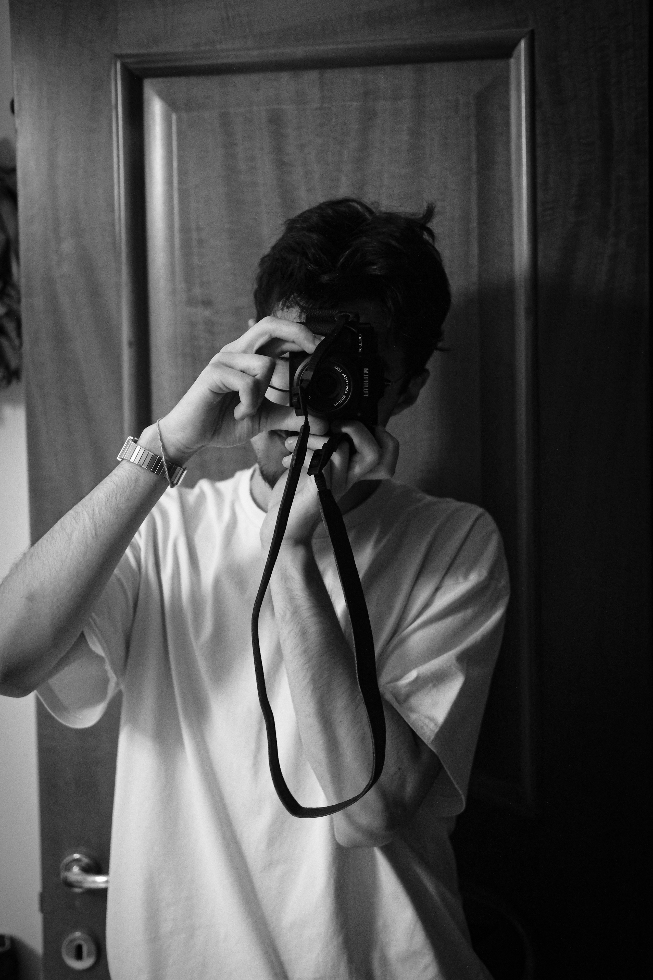 Angelo Tanzillo taking a self-portrait with a camera