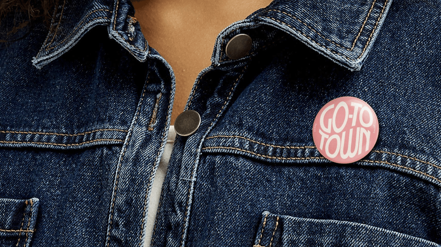 Large outdoor wall mural split vertically: a weathered pink field on the left and a pale concrete panel on the right bearing “AVANT GALLERY” in bold black at top and “Emma Carter – Reflections in Colour 5th December – 12th January” at bottom, set above a city pavement.