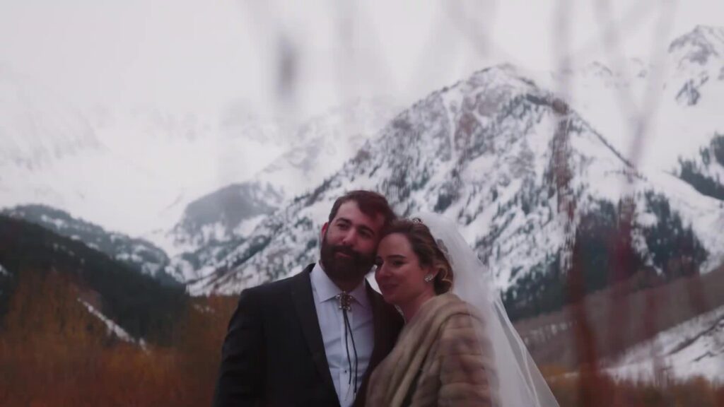Couple portrait at Pine Creek Cookhouse Ashcroft with snow-covered Elk Mountains in background winter wedding
