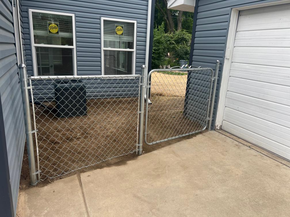 Graded backyard and new siding in construction of a home addition.