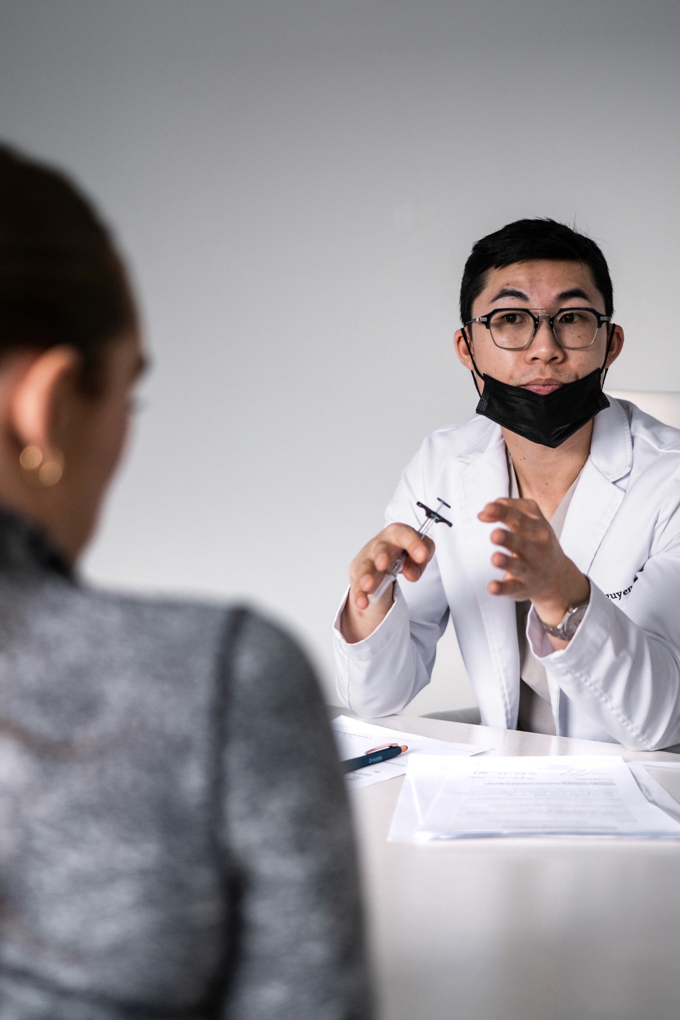 Dr Alex Nguyen in consultation with a patient