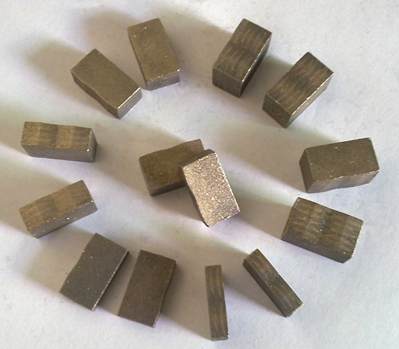  A group of small diamond segments arranged in a circular pattern, used in industrial saw blades for precision cutting of hard materials like stone and ceramics.