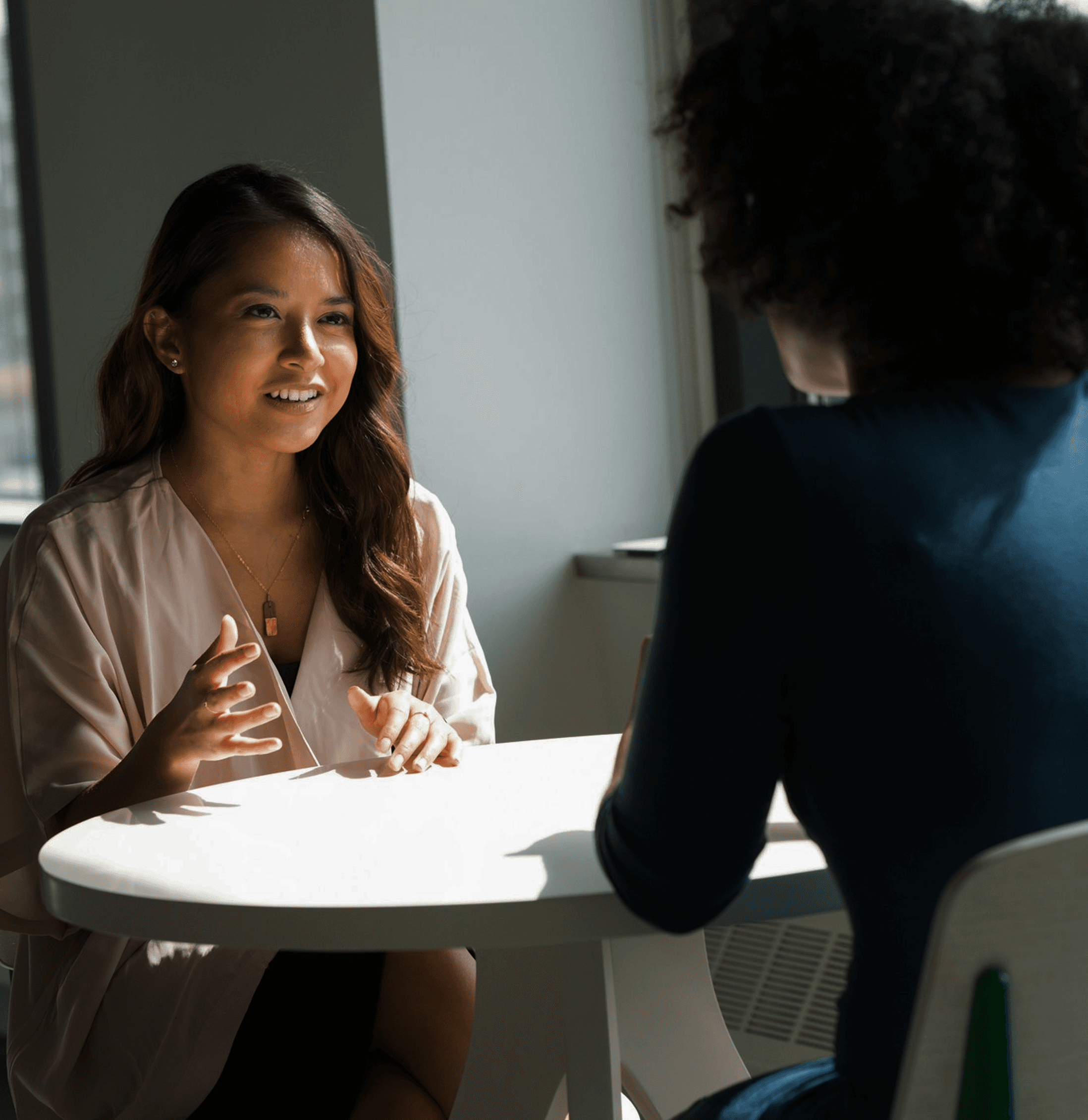Business meeting with two people discussing.