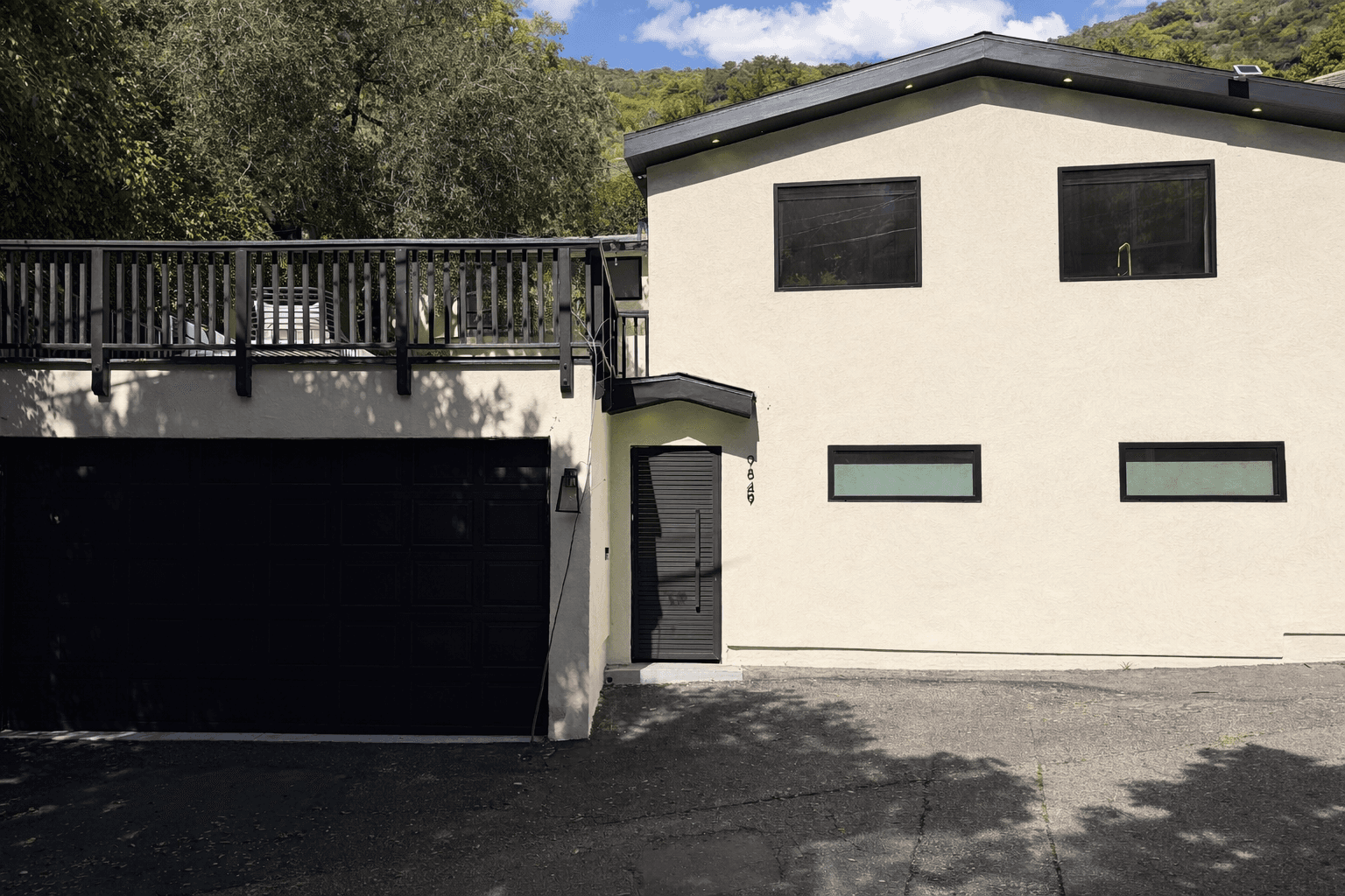 Elevated house with glass railings and scenic views
