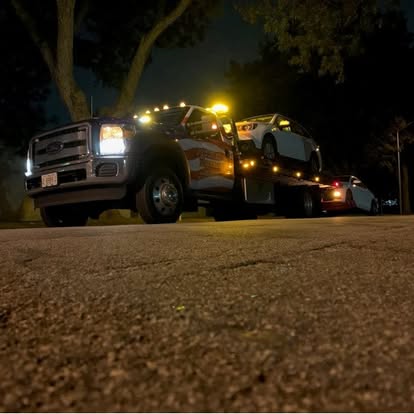 three people sitting in front of table laughing together