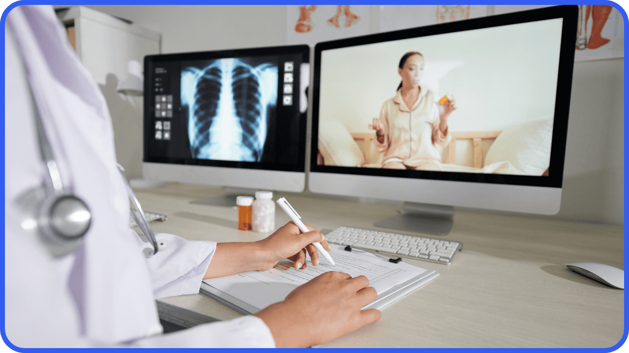 two screen monitors showing chest xray and patient while doctor is writing a prescription