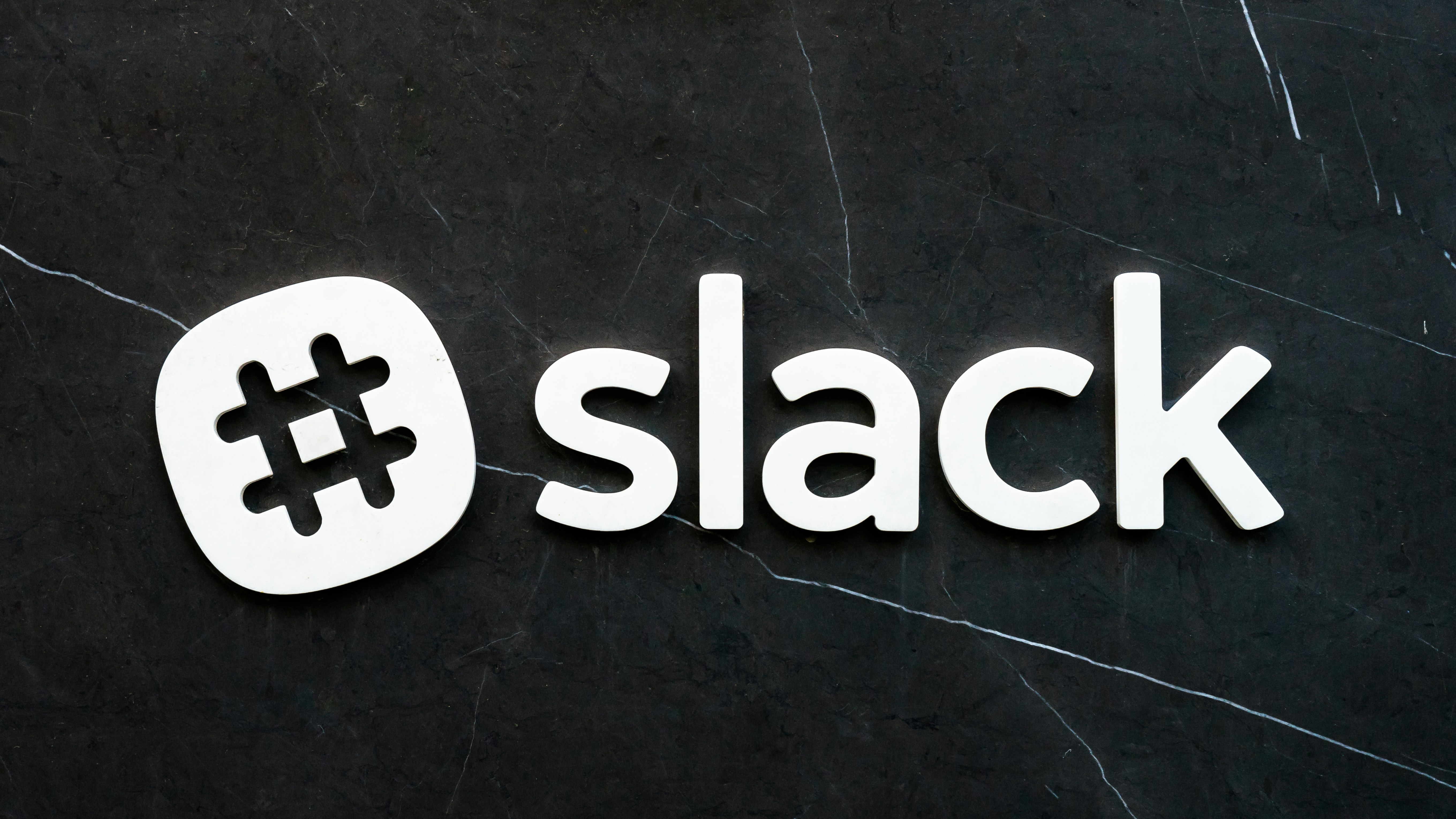 Slack messaging app logo on black background