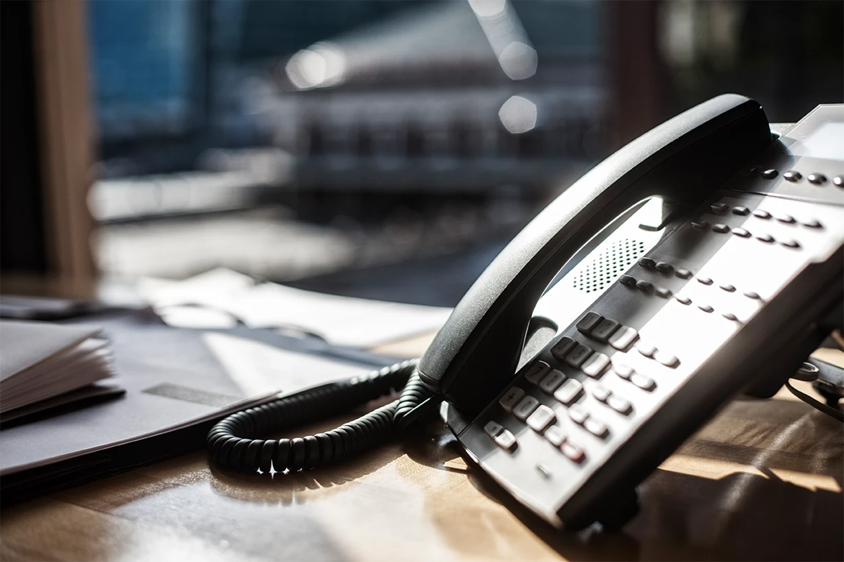 Attorney’s office desk with phone for scheduling a personal injury consultation