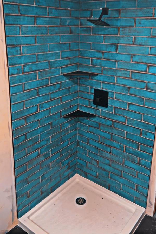 New shower in a bathroom renovation with beautiful turqouise tiles.