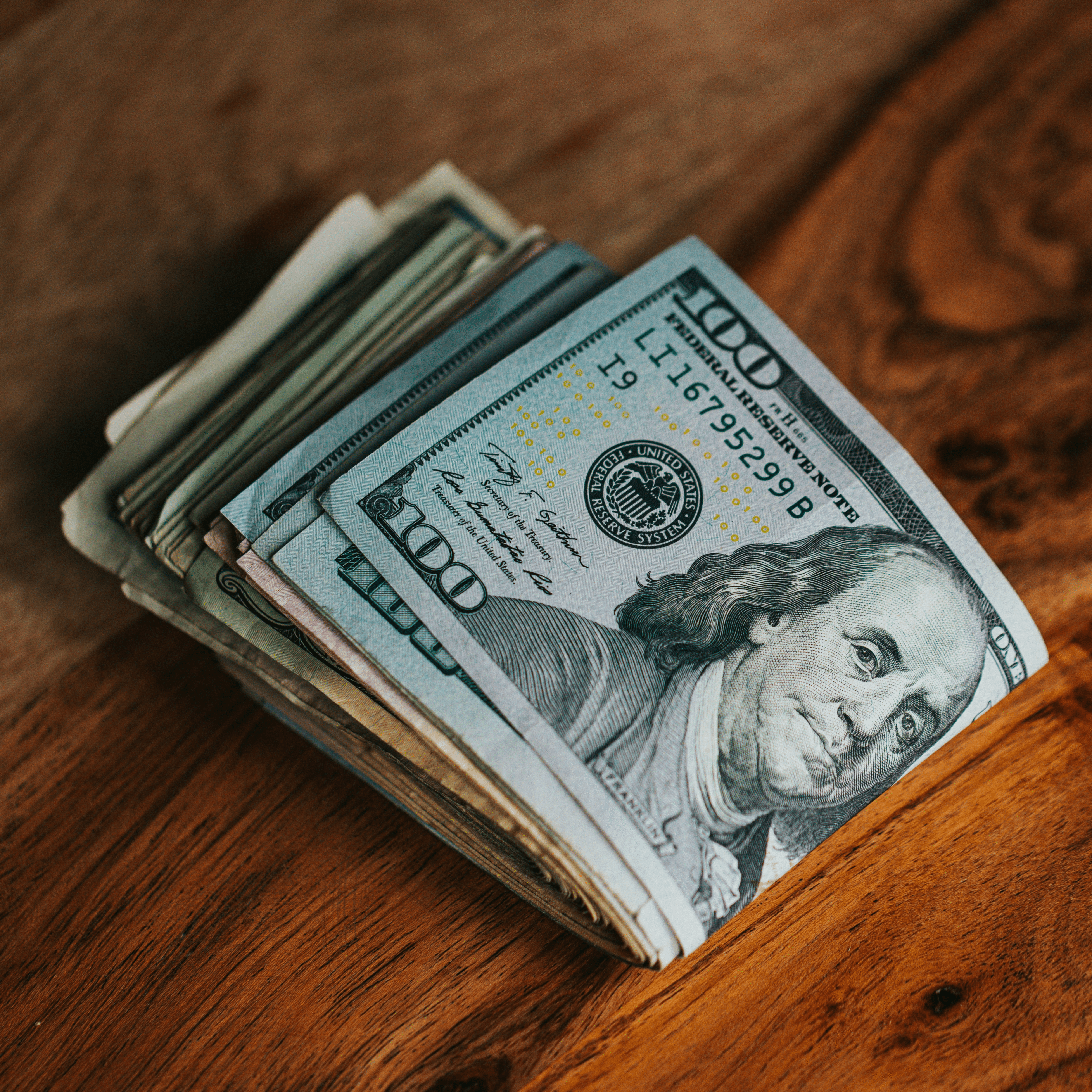 A stack of U.S. currency representing the financial shift from volume-based to value-based reimbursement in anesthesia