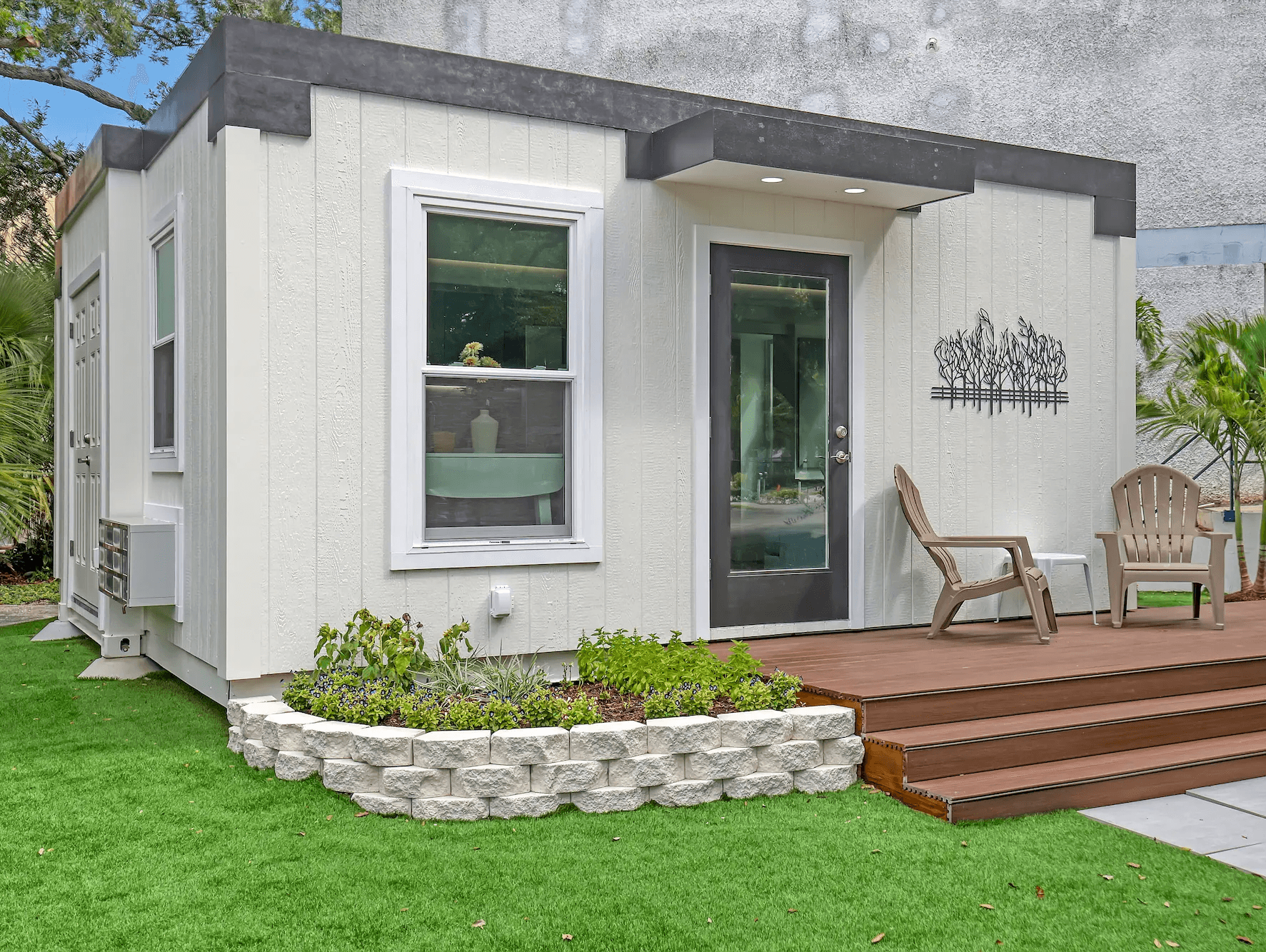 Small modern ADU exterior with solar panels and green surroundings