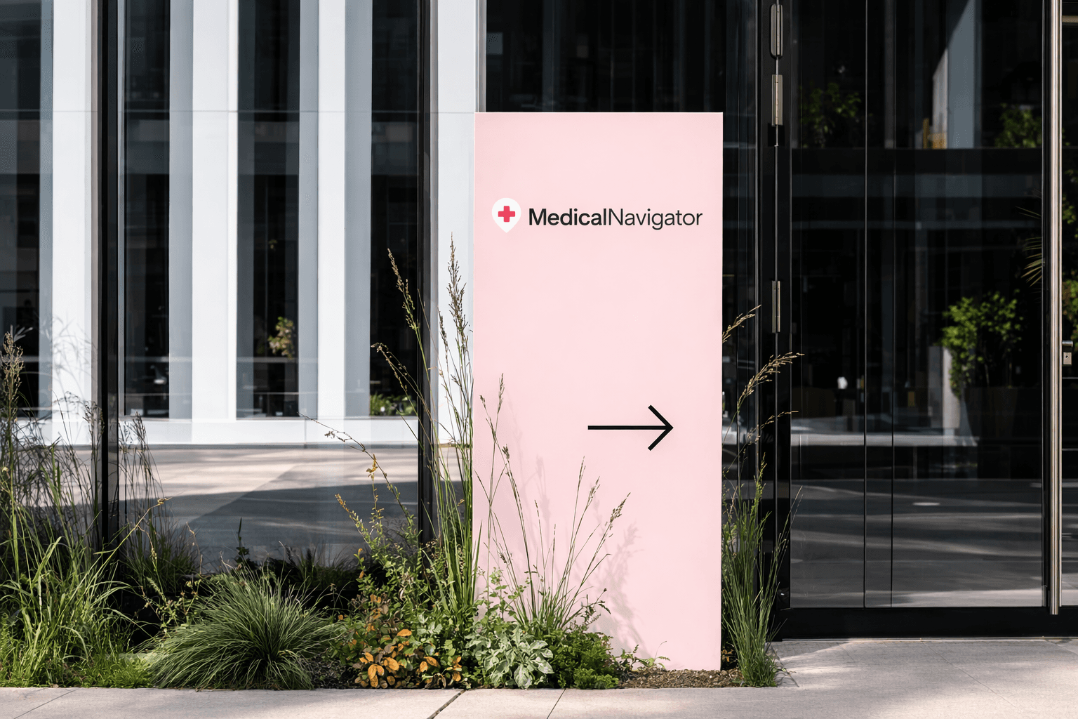 Yellow sign with "Midlands" text and arrow, surrounded by tall grass, pointing towards building entrance.