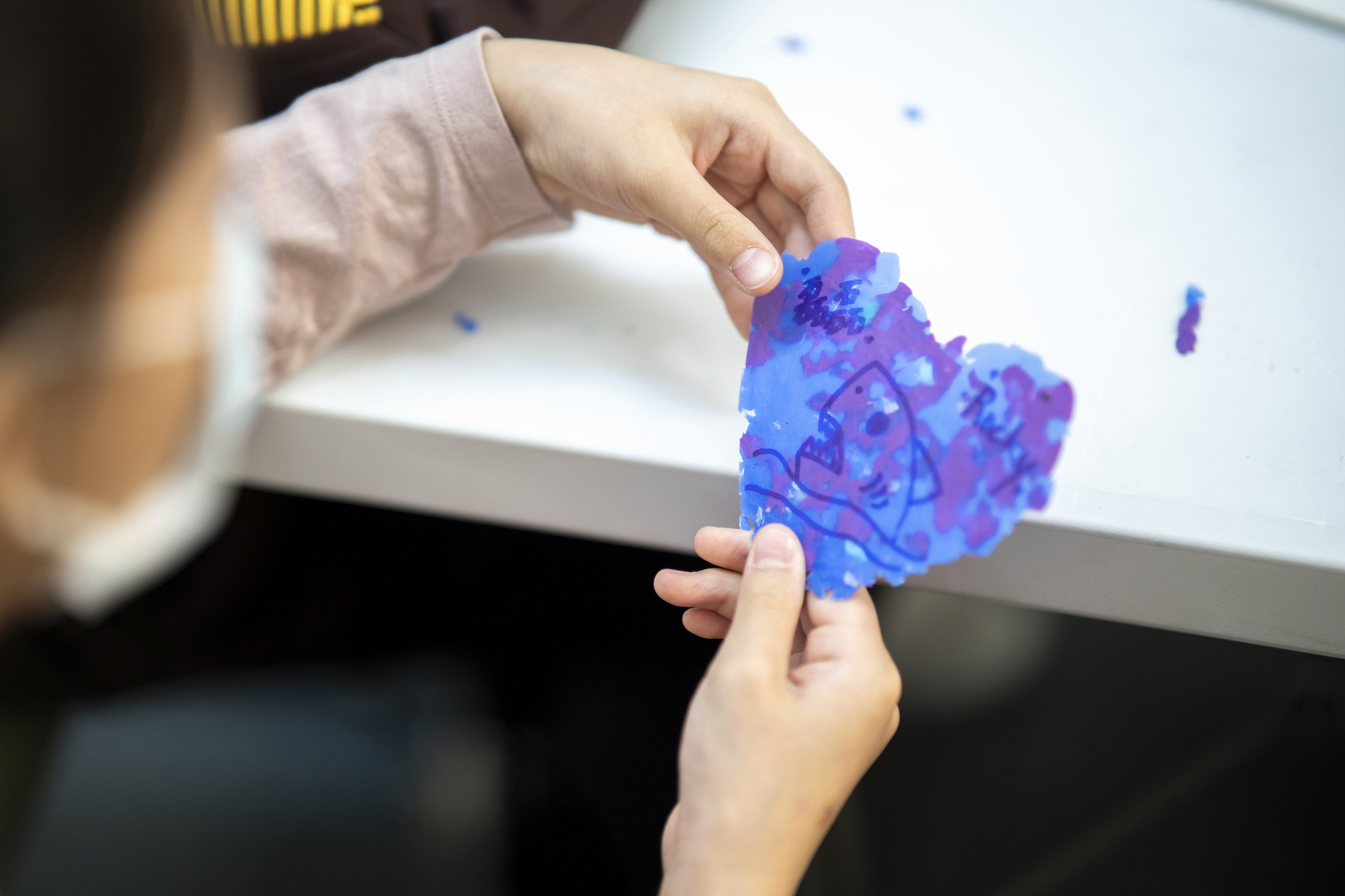 two ladies looking at a laptop and smiling