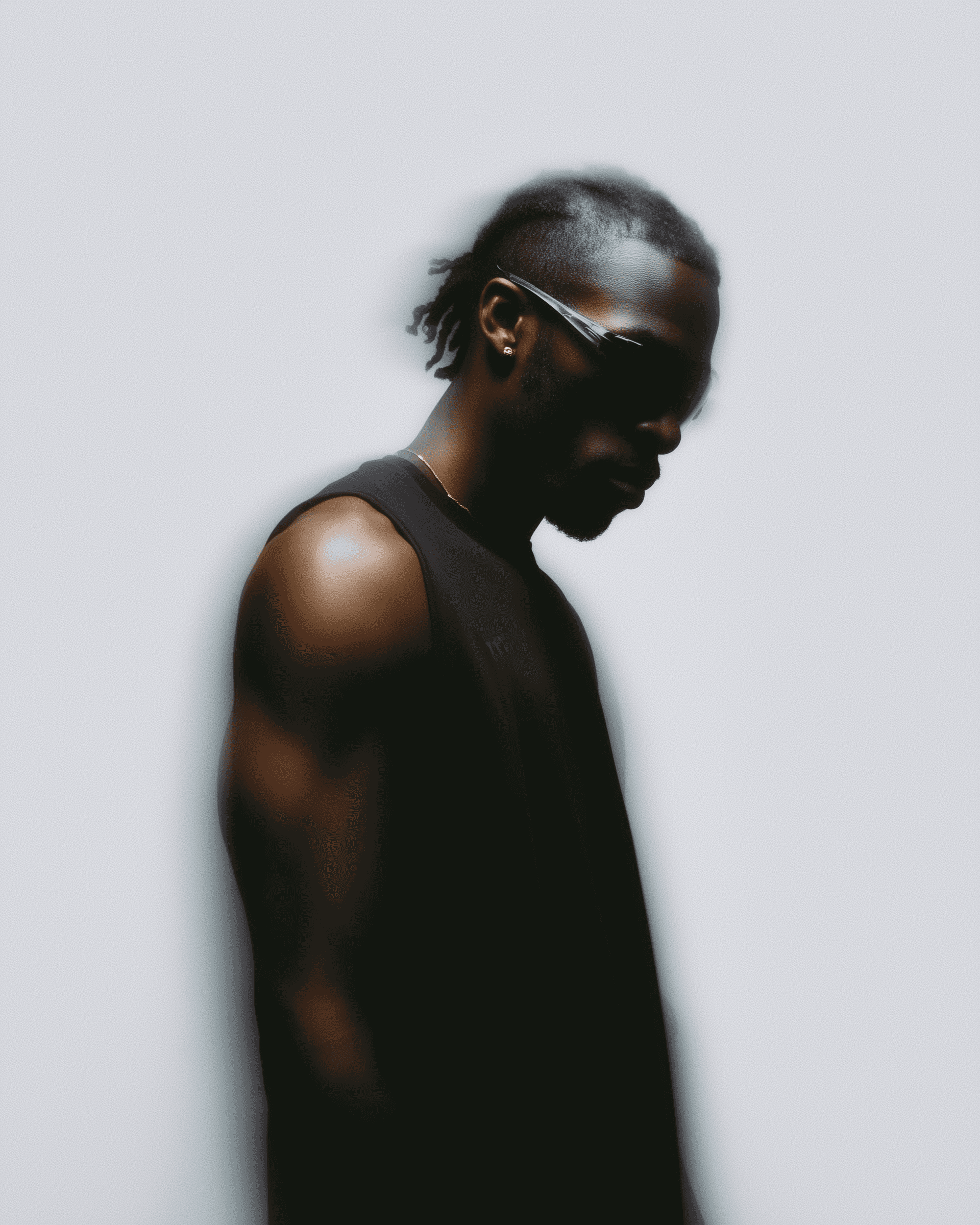 A black limousine parked at a gas station at night