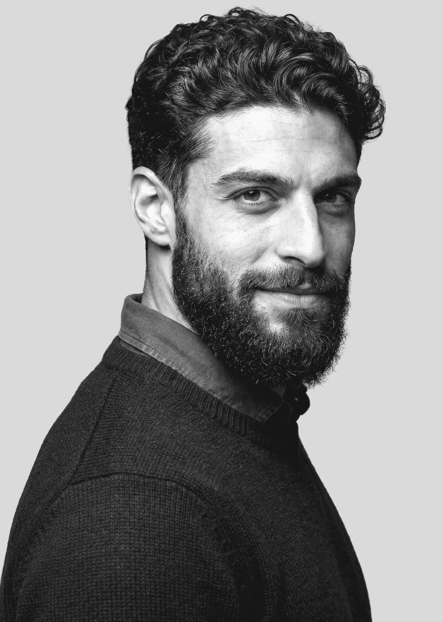 Young woman in a white shirt with a colorful gradient print, against a plain background.