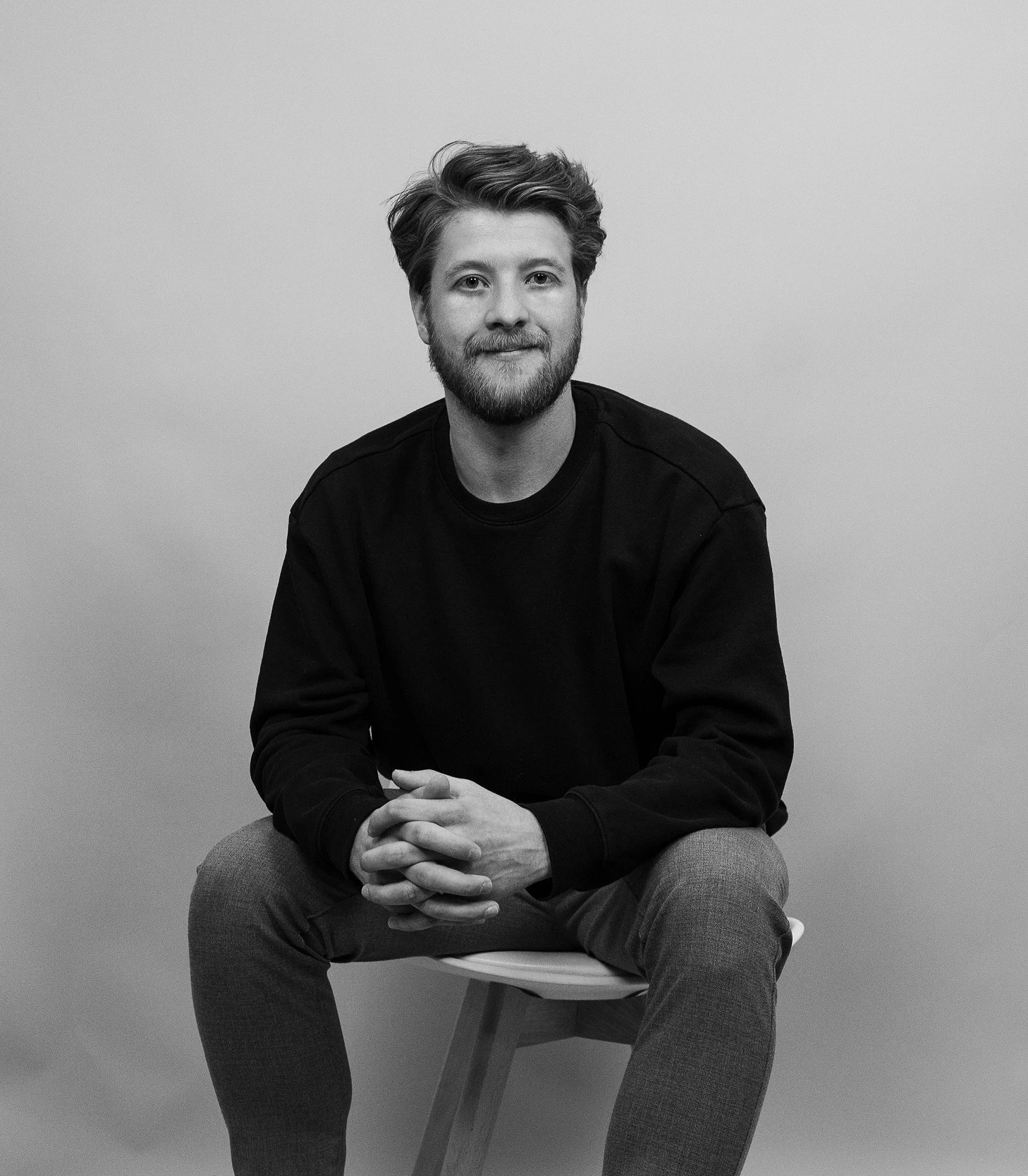 A portrait of Julian Garcia, brand designer and illustrator, in a creative studio workspace