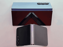 A modern foldable phone partly open, showing its inner display