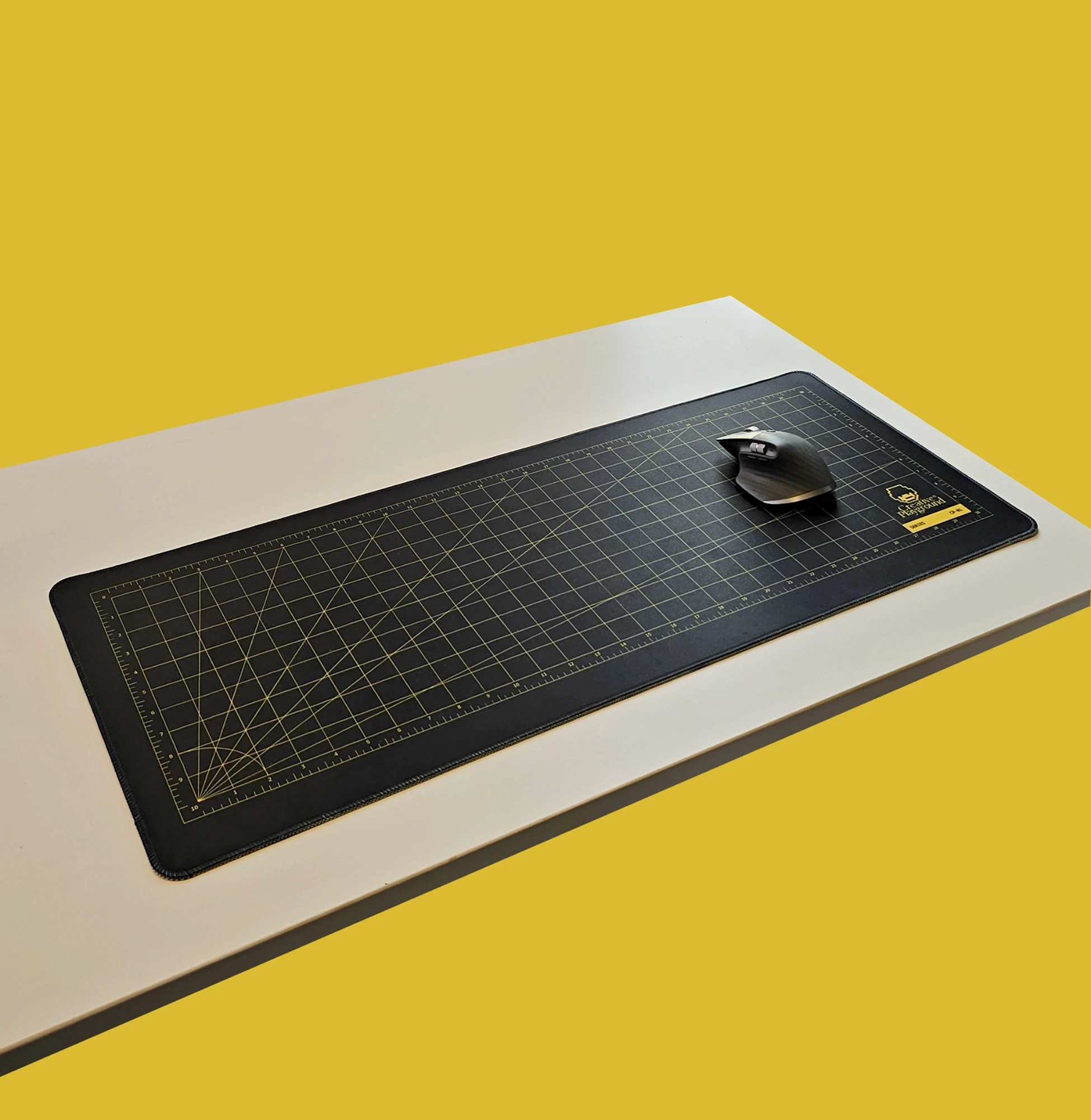 Cutting Mat Black on a white desk against a yellow background