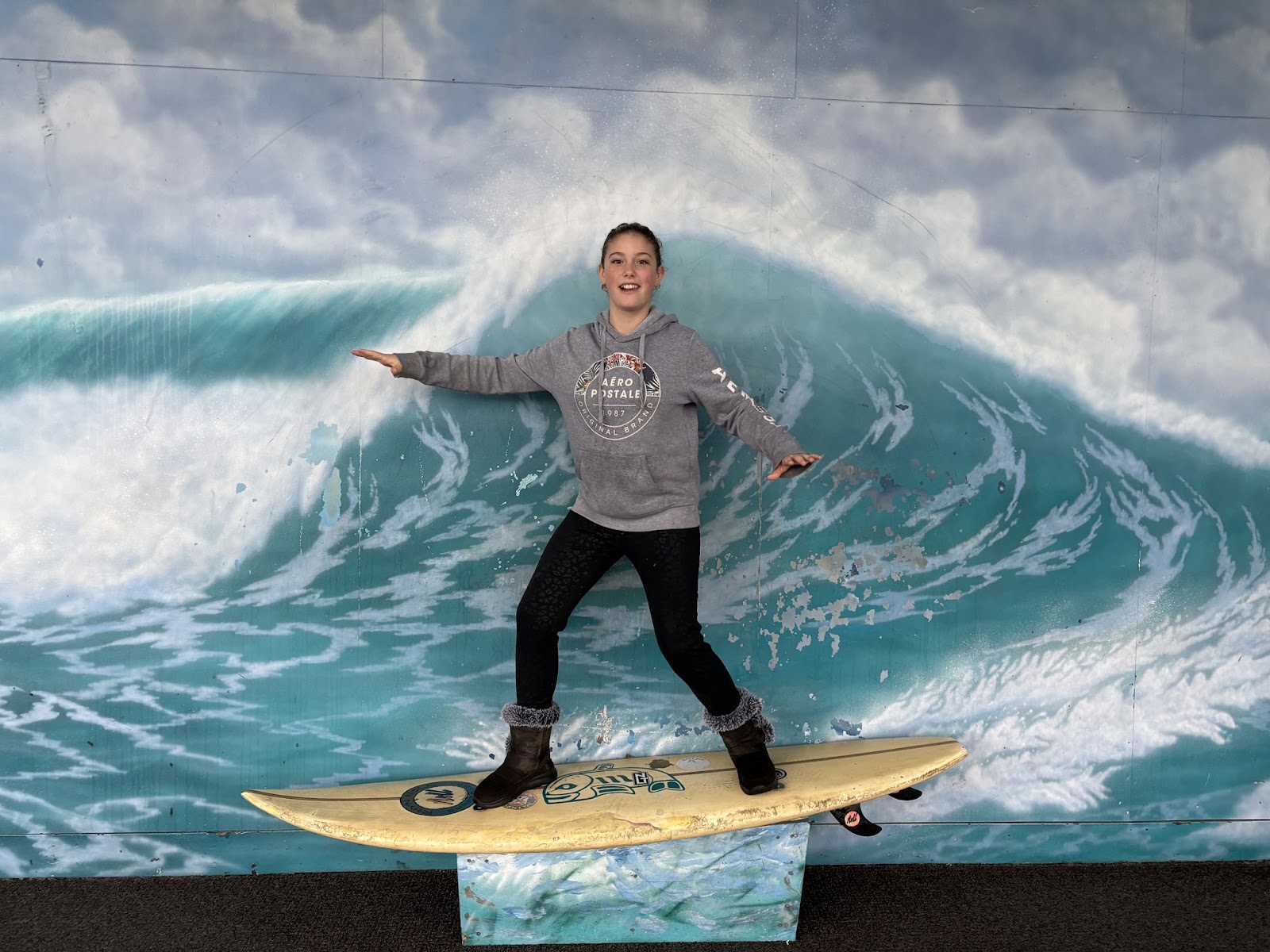 Eden posing on the surf mural in Crescent City