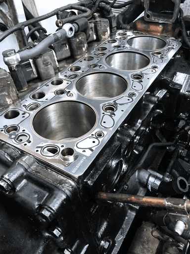 A close up of a car engine with its hood up